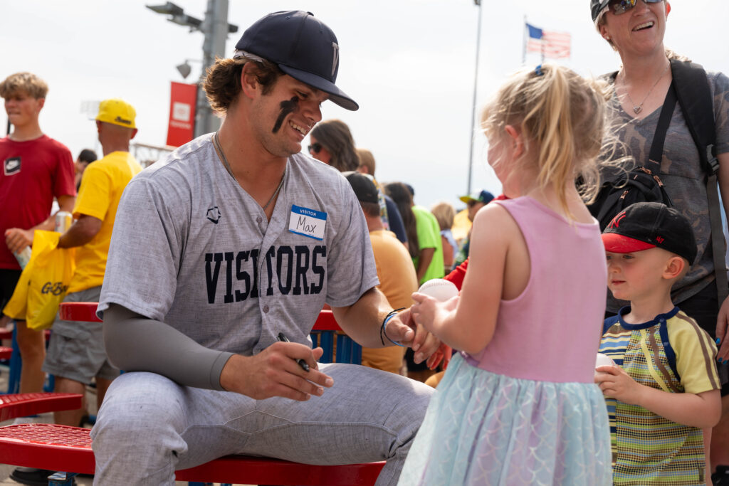 Max Fries signs an autograph for a fan of the Savannah Bananas at Indianapolis' Victory Field